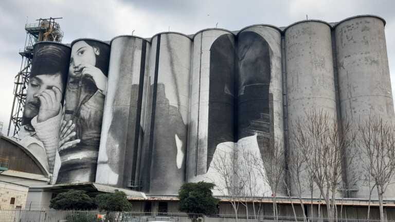 Bari, completata la prima parte dell’opera di Guido Van Helten sui silos: «Ispirato da San Nicola» – VIDEO